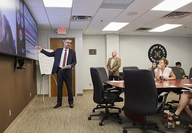image of a man presenting at a meeting