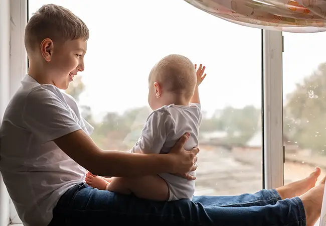 children sitting in front of a window