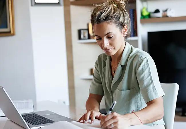 woman at laptop writing